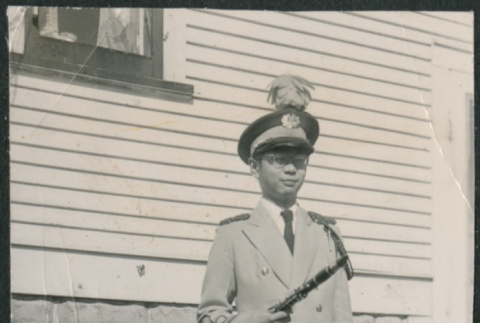 Teen in band uniform holding clarinet (ddr-densho-523-257)