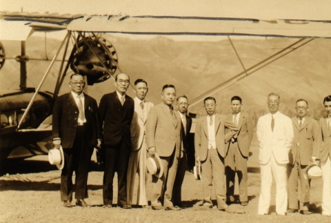 Kanekazu Okada and others posing by a plane (ddr-njpa-4-1980)
