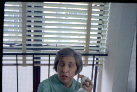 Woman sitting at desk, eating (ddr-densho-426-740)