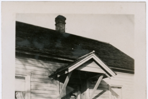 Man poses in front of home (ddr-densho-363-62)