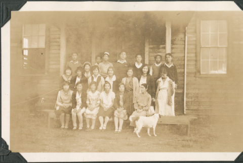 Group photo of women and men outside wooden building (ddr-densho-483-552)