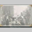 Group sitting at a table eating. (ddr-densho-434-233)