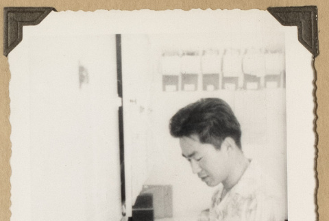 Man using equipment at a pharmacy counter (ddr-densho-542-503)