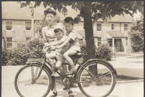 Woman with two children on a bicycle (ddr-densho-523-168)
