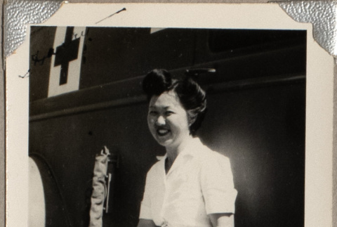 Woman sitting on bench by medical vehicle (ddr-densho-587-63)