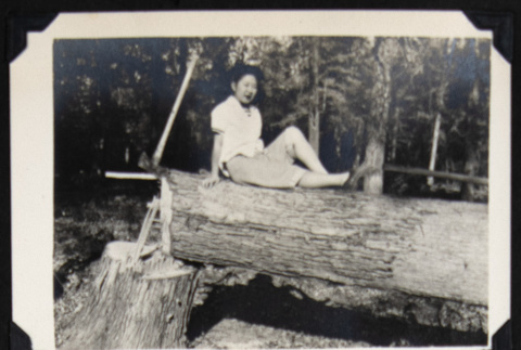 Nori poses with an ax and tree (ddr-densho-542-685)