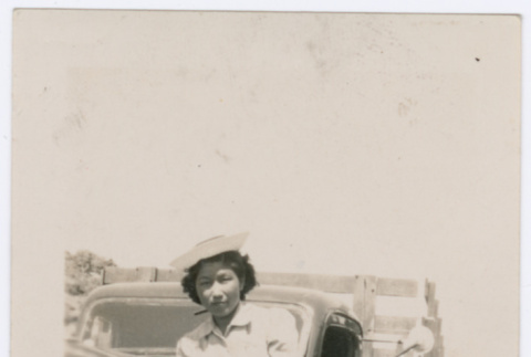 Woman poses on car (ddr-densho-363-8)