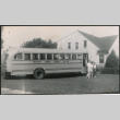 Three people standing next to school bus (ddr-densho-523-349)