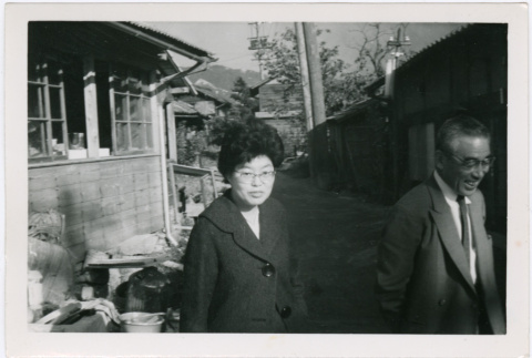 Tomoye Takahashi and unknown man outside building (ddr-densho-426-1082)