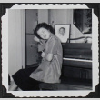 A girl sitting on a piano bench (ddr-densho-300-512)