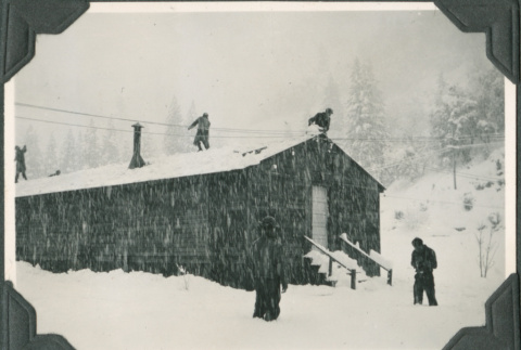 Men shoveling snow from barracks roof (ddr-ajah-2-290)