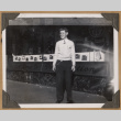 Man standing outside The Owl Drug Co. (ddr-densho-542-62)