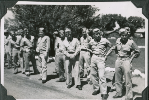Group of men standing on side of road (ddr-ajah-2-480)