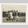 Nisei women standing outside a barrack (ddr-csujad-44-44)