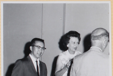 Three people at cocktail party (ddr-densho-522-129)