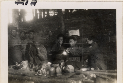 Ten soldiers around table with rations (ddr-densho-466-248)