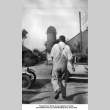 Man in overalls walking away from camera (ddr-ajah-6-423)