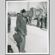 Man standing outside, group of men in background (ddr-densho-434-490)