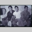 Three boys seated on bed (ddr-densho-330-172)