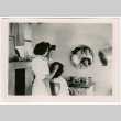 Two women styling another's hair (ddr-densho-475-429)