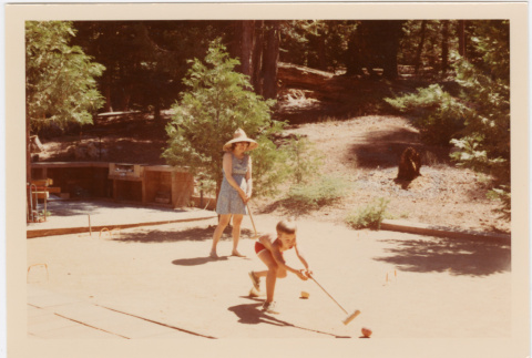 Tomoye Takahashi and young boy playing croquet (ddr-densho-426-1106)