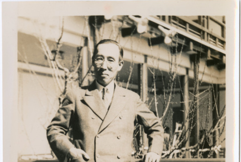 Man standing by railing of Japanese Pavilion at Golden Gate International Exposition (ddr-densho-426-1970)