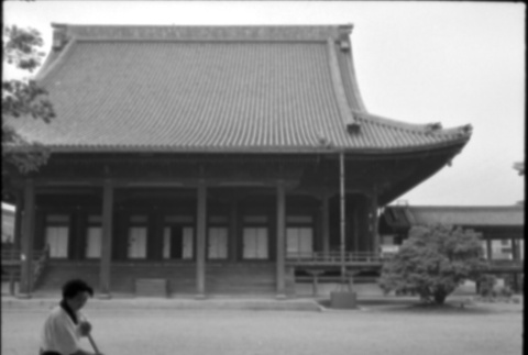 Woman sweeping in front of temple (ddr-densho-426-2337)