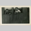 Young men leaning out a train car window (ddr-densho-37-917)
