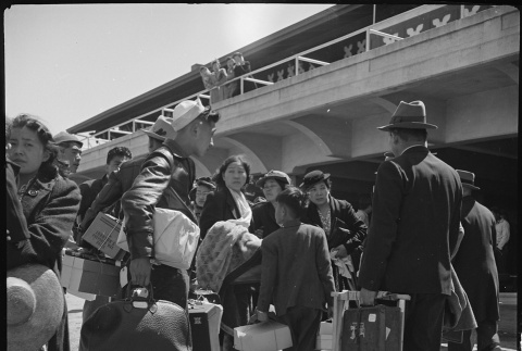 Japanese American family arriving at Tanforan (ddr-densho-151-154)