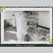 Man standing in kitchen making salads (ddr-densho-434-284)