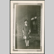Woman standing by brick wall (ddr-densho-293-109)