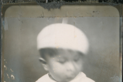 Baby in white beret being held by unidentified person (ddr-densho-483-603)