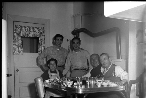 Frank with friends around a table (ddr-one-1-573)