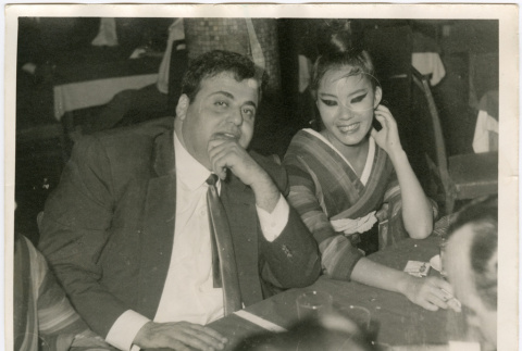 Man and women seated in restaurant (ddr-densho-426-817)