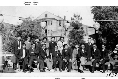 Group of men posing for photo outside house (ddr-ajah-6-189)