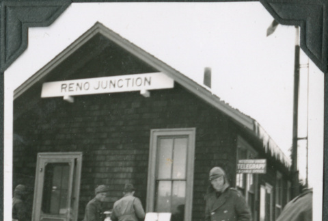 Group of men outside building with sign, Reno Junction (ddr-ajah-2-283)