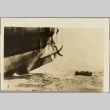 Men in a rowboat approaching the rear of a ship (ddr-njpa-13-619)