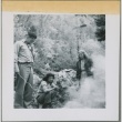 Larry and Guyo Tajiri around a campfire with friends (ddr-densho-338-236)