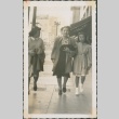 Mother and her daughters walking down the street (ddr-densho-321-1116)