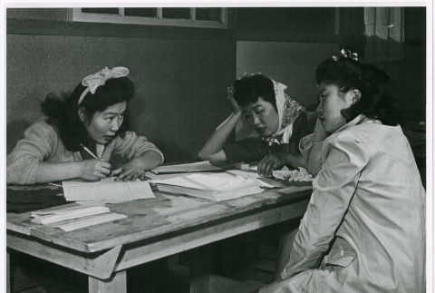 Nisei women filling our required registration (ddr-densho-122-753)