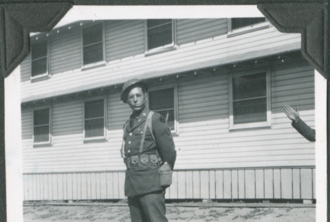 Man in uniform standing outside building (ddr-ajah-2-76)
