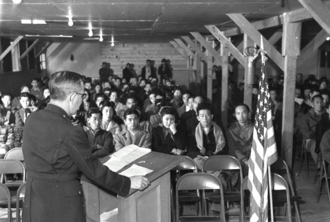 Man at podium addressing crowd (ddr-densho-1007-462)