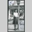 Photograph of Ruth standing next to a lamp post at a swimming pool (ddr-csujad-47-202)