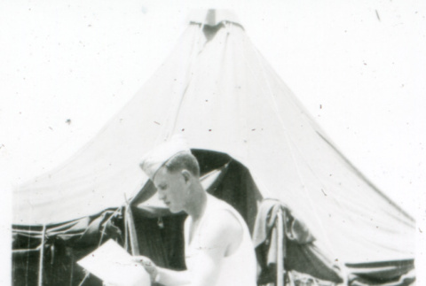 Soldier reading on stump (ddr-densho-1007-758)