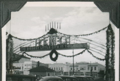 Banner over road with row of cars (ddr-ajah-2-278)