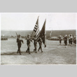 American soldiers marching with flags (ddr-densho-1007-595)