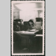 Man writing at desk (ddr-densho-368-570)