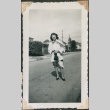 Woman in jacket poses in street (ddr-densho-321-252)
