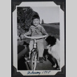 Boy on tricycle with dog (ddr-densho-359-1554)