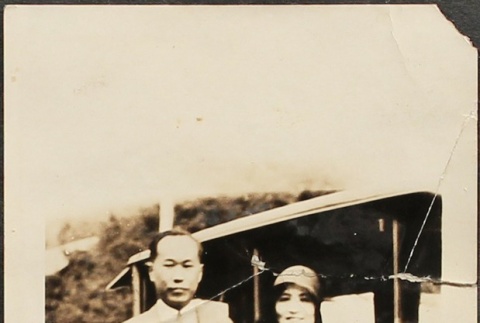 Issei man and woman in front of a black car (ddr-densho-259-218)